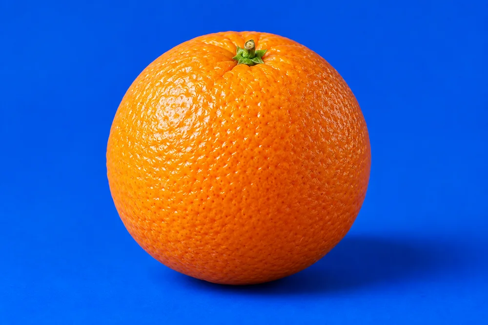 An orange on a blue background, original image